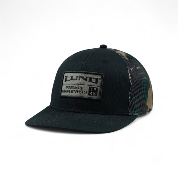 Angled front view of the black and camo Lund hat featuring a rectangular embroidered Lund patch on the front panel