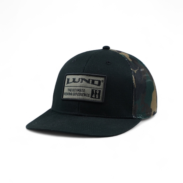 Angled front view of the black and camo Lund hat featuring a rectangular embroidered Lund patch on the front panel