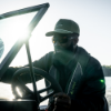 Man wearing Channel Hat while driving a boat
