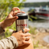 Lund Stainless Can Cooler on beach with boat