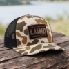 Lund Sportsman's hat in front of a lake